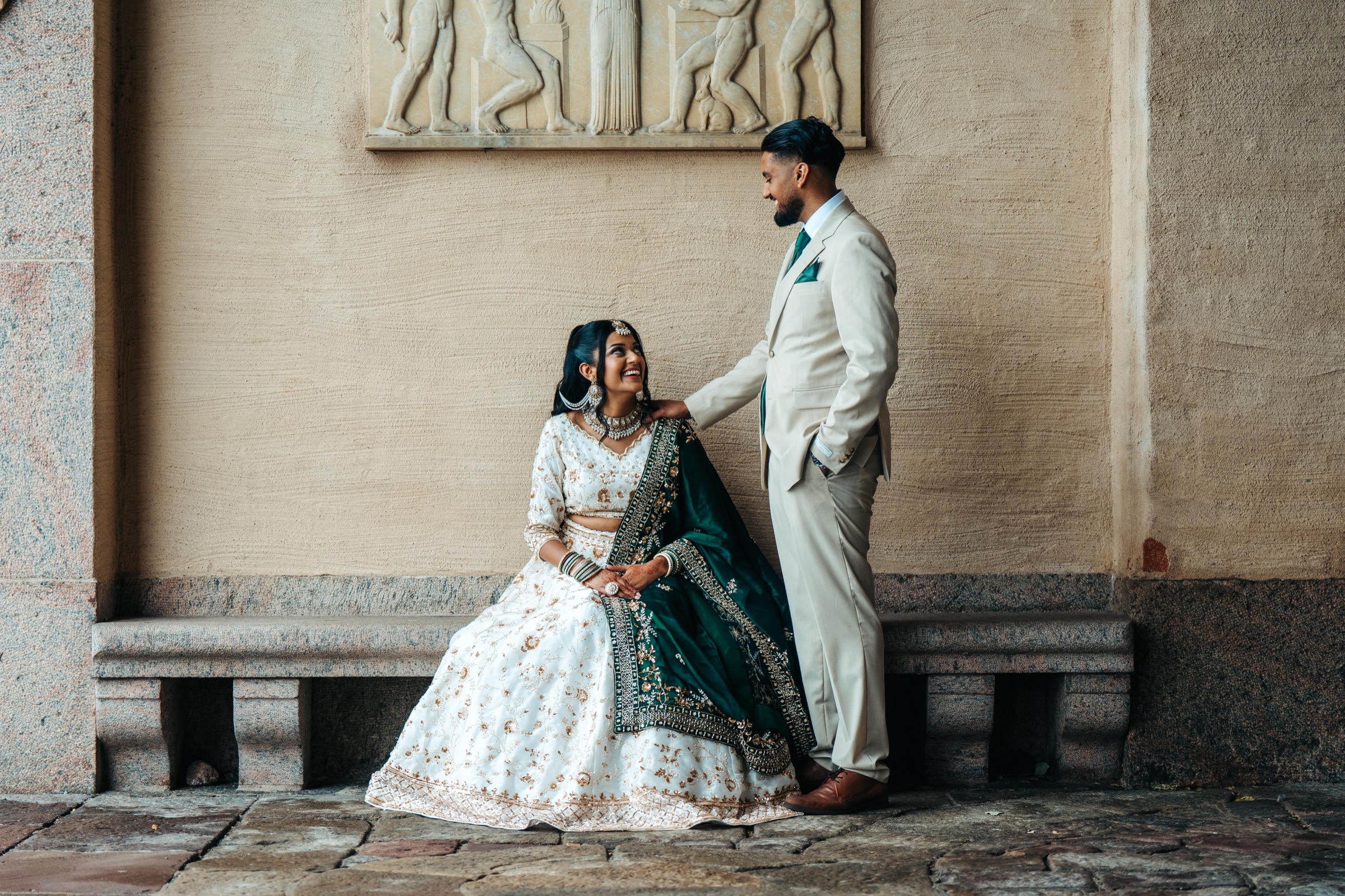 South Asian bride in editorial portrait at stone relief