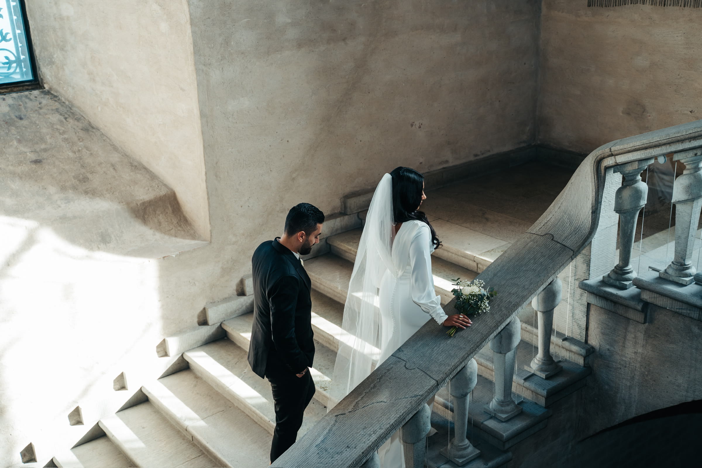 Couple on a sunlit stone staircase